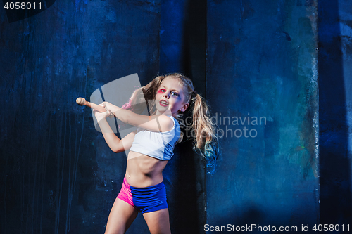 Image of Halloween theme: Girl with baseball bat ready to hit