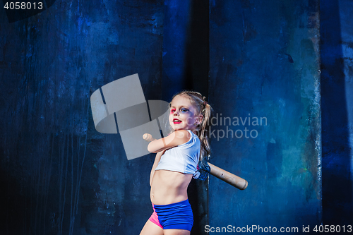 Image of Halloween theme: Girl with baseball bat ready to hit