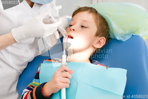 Image of Boy and dentist during a dental procedure