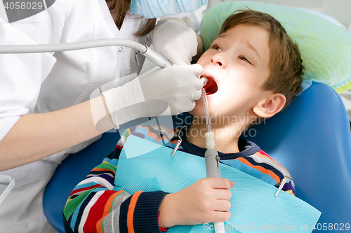 Image of Boy and dentist during a dental procedure