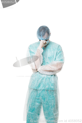 Image of Surgeon portrait. covered face with his hands. sad. isolated on white background
