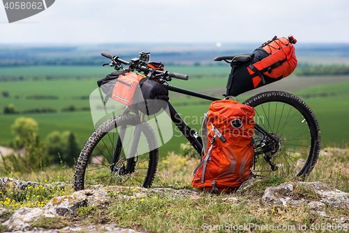 Image of Bicycle with orange bags for travel