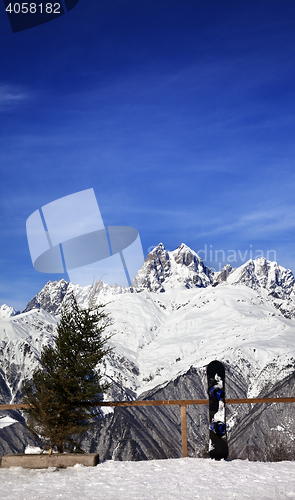 Image of Snowboard and felled fir-tree on viewpoint at ski resort