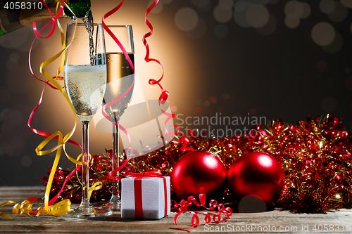 Image of Champagne fills the glasses and festive Christmas decorations