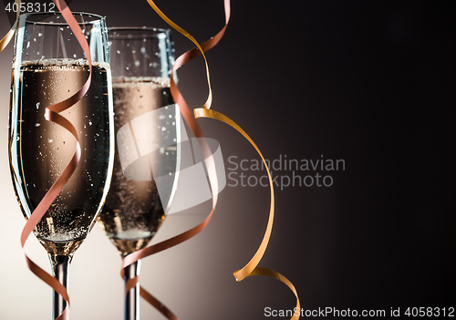 Image of Elegant image closeup of two champagne glasses and decorative ribbons