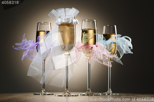 Image of Beautiful decorated wedding glasses with champagne
