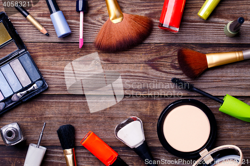 Image of Makeup cosmetics, brushes and other on brown background