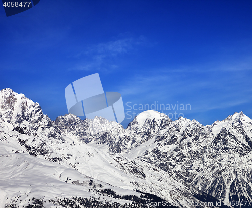 Image of Snow mountains and blue sky in winter at sun day