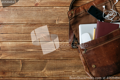 Image of Leather bag with gadgets and notebooks