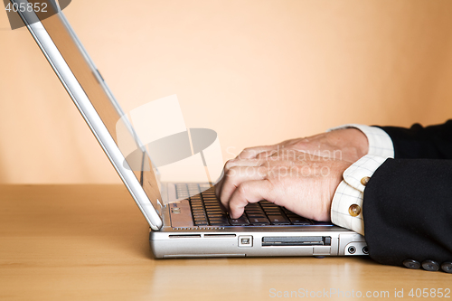 Image of Typing businessman