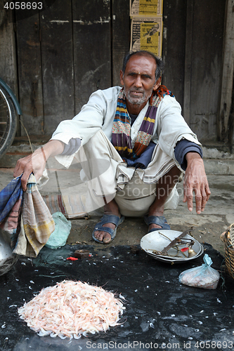 Image of Man selling prawns in Kumrokhali, West Bengal, India