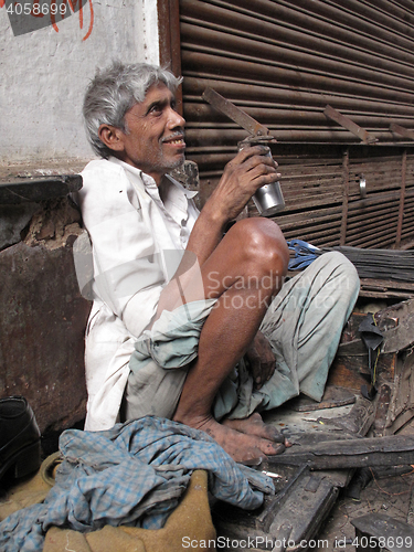 Image of Streets of Kolkata. Shoe shiner waiting for a customer