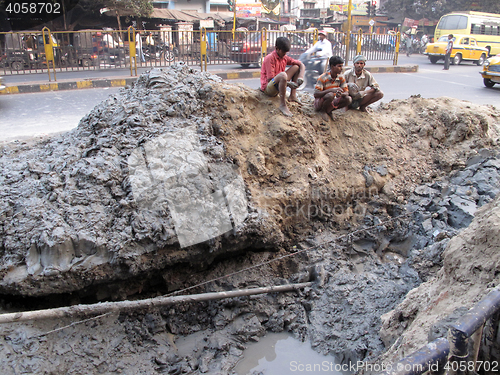 Image of Streets of Kolkata. People repair the road