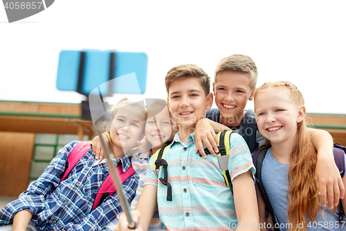 Image of happy elementary school students taking selfie