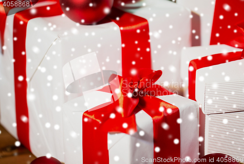 Image of close up of gift boxes and red christmas balls