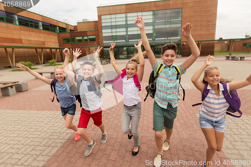 Image of group of happy elementary school students running