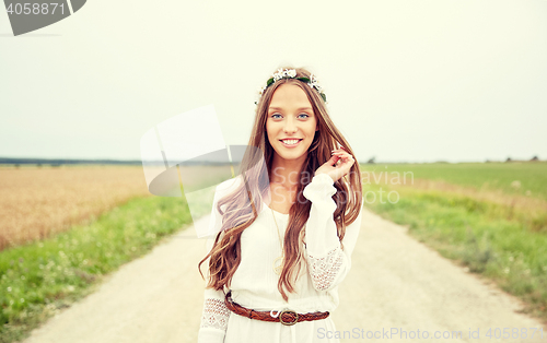 Image of smiling young hippie woman on cereal field