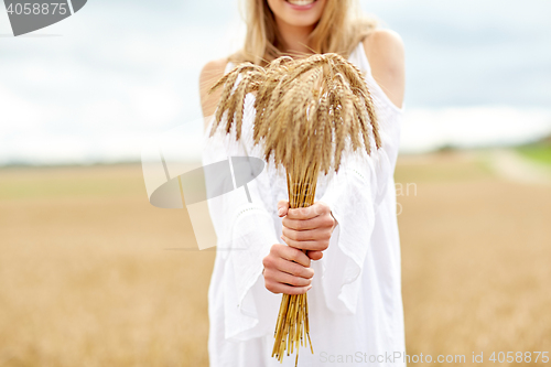 Image of close up of happy woman with cereal spikelets