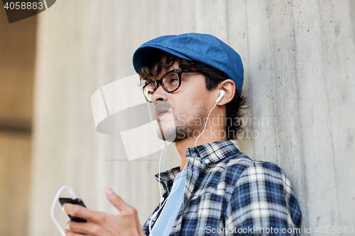 Image of man with earphones and smartphone listening music