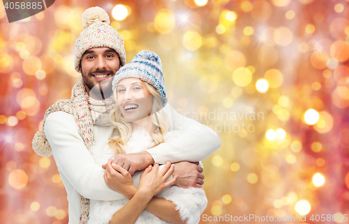 Image of smiling couple in winter clothes hugging