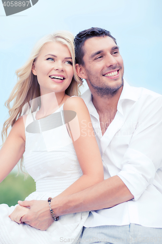 Image of couple in shades at sea side