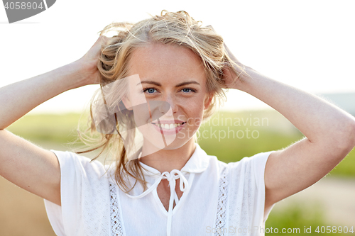 Image of close up of happy young woman in white outdoors