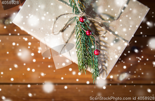 Image of close up of christmas gift box with fir brunch