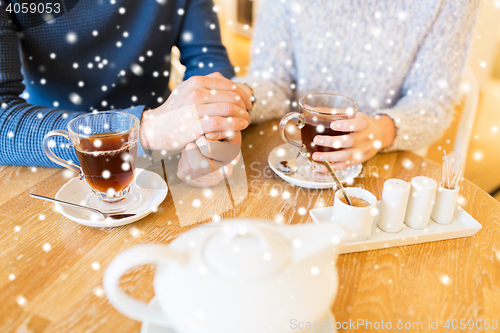 Image of close up of couple drinking tea at cafe