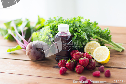 Image of bottle with beetroot juice, fruits and vegetables