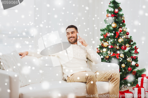 Image of man calling on smartphone at home for christmas