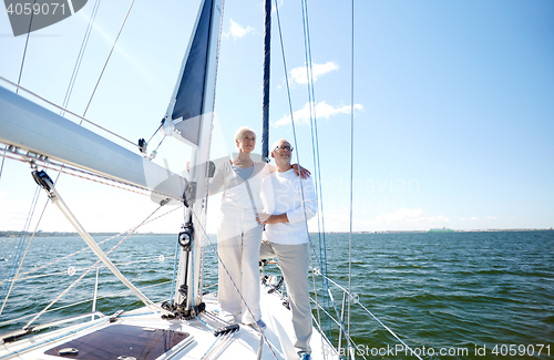 Image of senior couple hugging on sail boat or yacht in sea