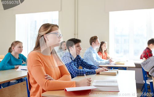 Image of group of students with books at school lesson