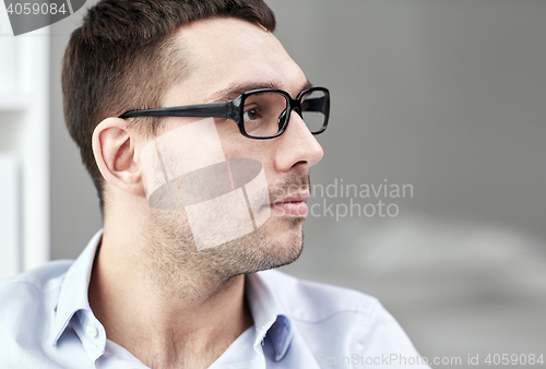 Image of portrait of businessman in eyeglasses at office