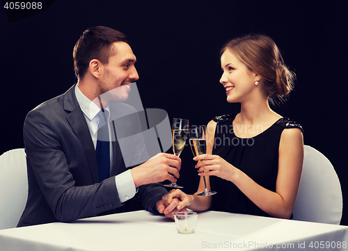 Image of couple with glasses of champagne at restaurant