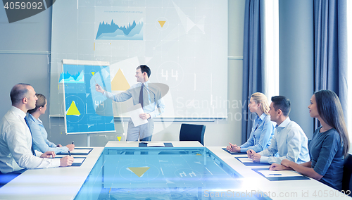 Image of group of smiling businesspeople meeting in office