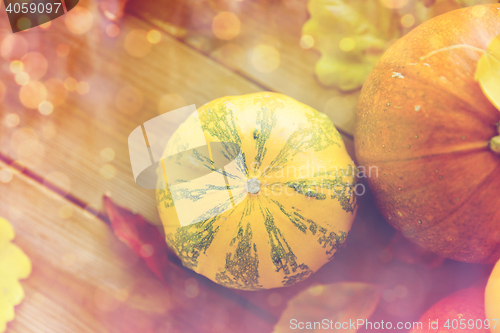 Image of close up of pumpkins on wooden table at home