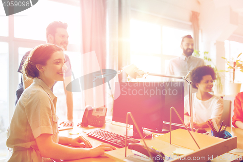 Image of happy creative team in office