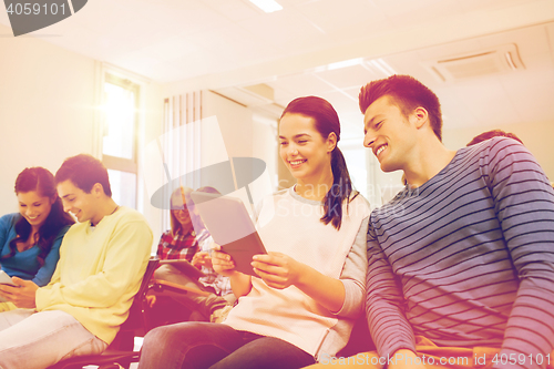 Image of group of smiling students with tablet pc