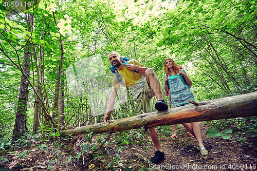 Image of group of smiling friends with backpacks hiking