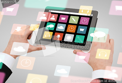 Image of close up of hands holding tablet pc with app icons