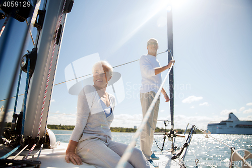 Image of senior couple hugging on sail boat or yacht in sea