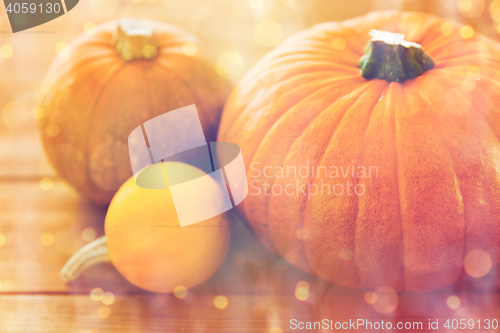 Image of close up of pumpkins on wooden table at home