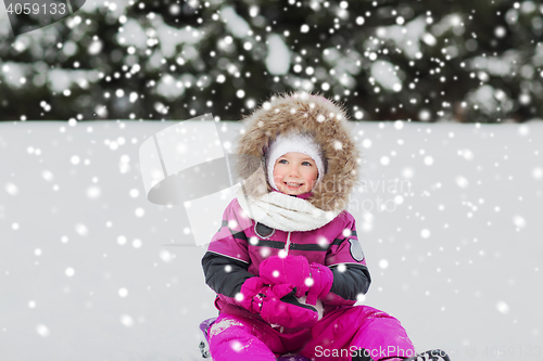 Image of happy little kid on sled outdoors in winter