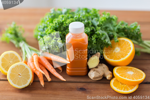 Image of bottle with carrot juice, fruits and vegetables