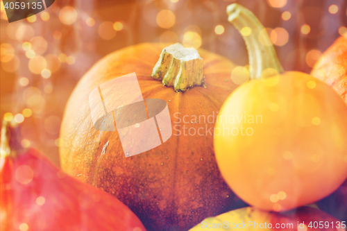 Image of close up of pumpkins on wooden table at home