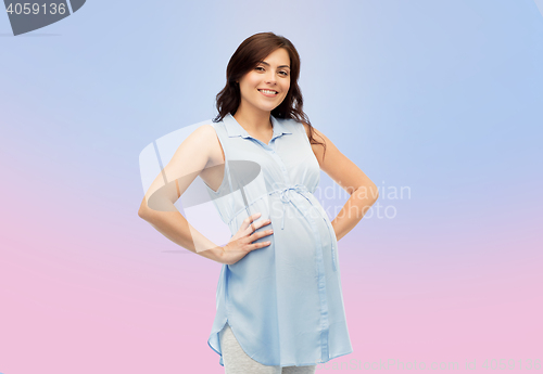 Image of happy pregnant woman touching her big belly