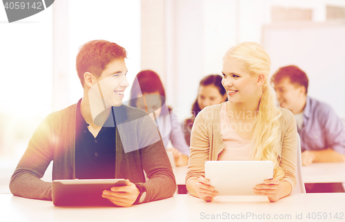 Image of students looking at tablet pc in lecture at school