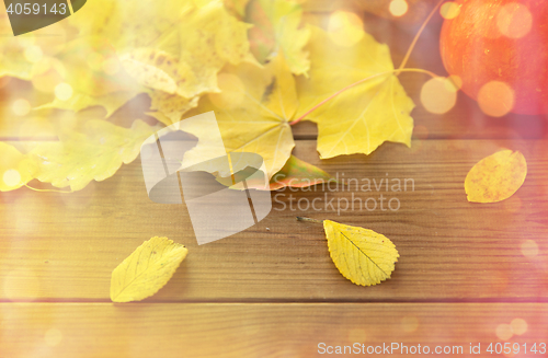 Image of close up of pumpkins on wooden table at home