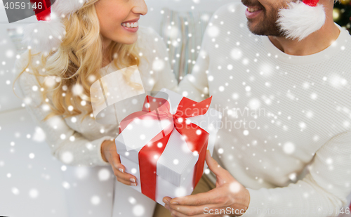 Image of close up of couple with christmas gift at home