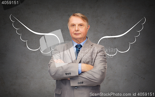 Image of senior businessman with angel wings over gray